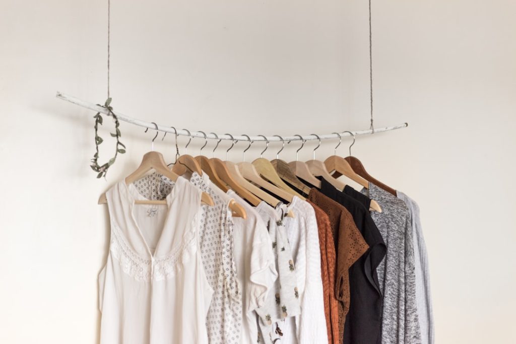 assorted-clothes-in-wooden-hangers-dlxlgiy-2vu